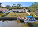 Waterfront property with a fenced yard, boat dock, and direct water access for boating and recreation at 18350 Burkholder Cir, Port Charlotte, FL 33948