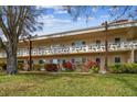 Low-rise condo building showcasing well-manicured lawns and vibrant flowerbeds at 2280 World Parkway Blvd # 34, Clearwater, FL 33763