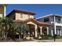 Charming two-story home featuring a terracotta roof, arched entry, and manicured landscaping at 249 Iron Age St., Safety Harbor, FL 34695