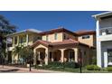 Charming two-story home featuring a terracotta roof, arched entry, and manicured landscaping at 249 Iron Age St., Safety Harbor, FL 34695