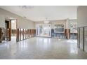 Spacious living room with walls partially removed, light fixtures, and a glass patio door at 2491 Coronado Way, Dunedin, FL 34698