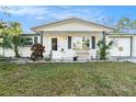 Cozy front porch of home featuring seating, plants and decor at 3624 Wiltshire Dr, Holiday, FL 34691