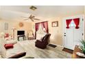 Cozy living room with tile floors, ceiling fan and front door access at 3624 Wiltshire Dr, Holiday, FL 34691