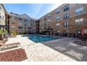 Community swimming pool with lounge chairs and a beautifully designed brick paver deck at 4221 W Spruce St # 1325, Tampa, FL 33607