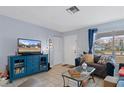 Cozy living room with a comfortable sofa, stylish furnishings, and a bright window, creating an inviting space at 4553 Kirkland Ave, Spring Hill, FL 34606