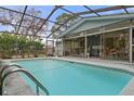 Relaxing screened-in pool area features a refreshing pool, outdoor seating and a convenient serving area at 4553 Kirkland Ave, Spring Hill, FL 34606