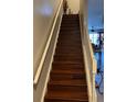 Stairway featuring hardwood steps, white risers and railings at 4915 Pond Ridge Dr, Riverview, FL 33578