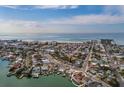 Aerial view of the home showing the waterfront location close to the beach, and the community at 7013 Boca Ciega Dr, St Pete Beach, FL 33706