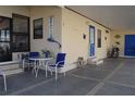 Welcoming covered patio with a table, chairs, and charming nautical decorations at 7129 El Rancho Way, Zephyrhills, FL 33541