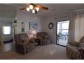Cozy living room featuring plush seating, natural light, and access to the sunroom at 7129 El Rancho Way, Zephyrhills, FL 33541