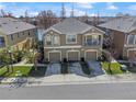 Aerial view of a two story townhome featuring three car garages and an open balcony at 8835 Moonlit Meadows Loop, Riverview, FL 33578