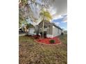 Well maintained exterior of a single Gathering home displaying neatly arranged landscaping with rock covering at 10251 Oasis Palm Dr, Tampa, FL 33615