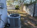 Exterior side yard with a newer HVAC system and a view of the backyard fencing and mature landscaping at 11470 88Th Ter, Seminole, FL 33772
