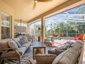 Inviting covered patio with comfortable seating and a view of the screened-in pool at 15720 Ibisridge Dr, Lithia, FL 33547