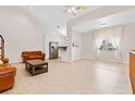 Bright and airy living room featuring neutral walls, tile floors, and a view of the modern, bright kitchen at 2003 Mcmullen Ave, Dunedin, FL 34698