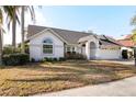 Charming single-story home with a well-manicured lawn, two car garage and a welcoming front entrance at 3414 Shady Brook Ln, Sarasota, FL 34243