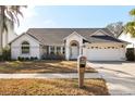 Charming single-story home with a well-manicured lawn, two car garage and a welcoming front entrance at 3414 Shady Brook Ln, Sarasota, FL 34243