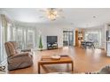 Bright living room with hardwood floors, a ceiling fan, and a large window at 36645 Kay Ave, Zephyrhills, FL 33542