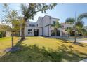 Striking modern home with a well-manicured lawn and mature trees, offering curb appeal at 4110 W Swann Ave, Tampa, FL 33609