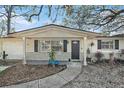 Inviting home featuring a well-manicured lawn, classic shutters and a cozy front porch at 4928 Petunia Ct, New Port Richey, FL 34652
