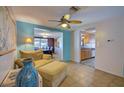 Inviting living room showcasing tile flooring and open access to the dining area and kitchen at 5313 Baroque Dr, Holiday, FL 34690