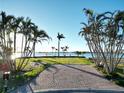 Waterfront backyard with palm trees and a brick paver driveway at 561 173Rd E Ave, North Redington Beach, FL 33708