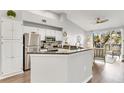 Bright kitchen featuring white cabinets, stainless steel appliances, and granite countertops at 628 Arbor Lake Ln, Tampa, FL 33602