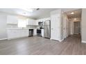 Open kitchen featuring stainless steel appliances, white cabinets, and hardwood floors at 701 15Th S Ave, St Petersburg, FL 33701
