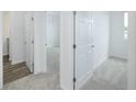 Bright hallway with neutral carpet and white doors leading to bedrooms and a tiled bathroom at 7529 62Nd N Way, Pinellas Park, FL 33781