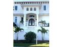 Inviting home entrance with classic architectural details, lush landscaping, and a grand doorway at 1855 Bayou Grande Ne Blvd, St Petersburg, FL 33703