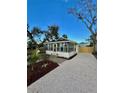 Exterior view showcases the well-maintained home with a stone driveway and neat landscaping at 3221 17Th N St, St Petersburg, FL 33713