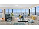 Elegant living room featuring hardwood floors, bright windows with water views, and stylish furnishings at 3301 Bayshore Blvd # 1908B, Tampa, FL 33629