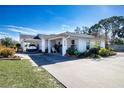 Charming home featuring a spacious driveway, two carports, and a beautifully landscaped front yard at 4010 N Lockwood Ridge Rd, Sarasota, FL 34234