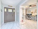 Inviting foyer with decorative front door and a view into the bright office space at 4810 Centerbrook Ct, Tampa, FL 33624