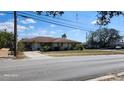 Charming single-story house with well-kept lawn, mature trees, and accessible street parking at 5507 Riddle Rd, Holiday, FL 34690