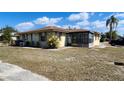 Single Gathering home featuring an enclosed patio area and a partially dry lawn at 5507 Riddle Rd, Holiday, FL 34690