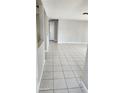 Bright living room with tile flooring, freshly painted walls, and an open layout at 5507 Riddle Rd, Holiday, FL 34690