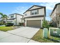 Two-story home featuring a well-maintained lawn and a two-car garage at 7673 Yale Harbor Dr, Wesley Chapel, FL 33545