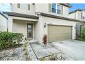 Home featuring a well-maintained lawn and a two-car garage at 7673 Yale Harbor Dr, Wesley Chapel, FL 33545