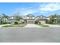 A neighborhood street view showing houses with well-kept lawns at 7673 Yale Harbor Dr, Wesley Chapel, FL 33545
