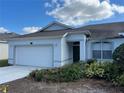Lovely single-story home featuring an attached two-car garage and green front lawn at 8019 Brien Green Way, Temple Terrace, FL 33637