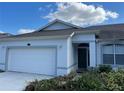 Charming one-story home featuring a two-car garage and a freshly sealed driveway at 8019 Brien Green Way, Temple Terrace, FL 33637