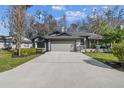 Charming single-story home with a two-car garage, landscaped yard, and inviting curb appeal at 887 Lucas Ln, Oldsmar, FL 34677