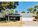 Charming single-story home with a well-maintained lawn and attached two-car garage at 8979 Hernando Way, Weeki Wachee, FL 34613