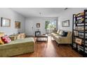 Cozy living area featuring wood floors, comfortable seating, and a sliding door to a balcony with outdoor views at 10263 Gandy N Blvd # 209, St Petersburg, FL 33702