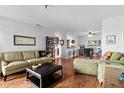 A bright living room with wood floors, open to the kitchen, and tastefully furnished with comfortable seating at 10263 Gandy N Blvd # 209, St Petersburg, FL 33702