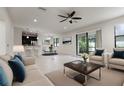Open-concept living area with kitchen view, modern furnishings, neutral tones, and ample natural light at 11008 Tahiti Isle Ln, Tampa, FL 33647