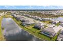 View from above a neighborhood of luxury homes in a gated community with ponds and landscaping at 15315 Golden Beam Pl, Bradenton, FL 34211