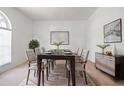 Bright dining room with a dark wood table, neutral chairs, and elegant decor at 1545 Deerbourne Dr, Wesley Chapel, FL 33543