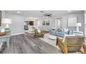 Spacious living room with hardwood floors, contemporary furnishings, and ample natural light at 1811 Forest Dr, Oldsmar, FL 34677